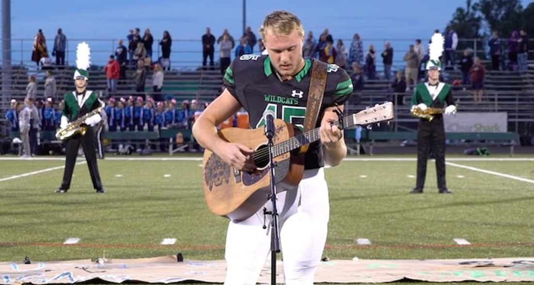 No one was willing to sing the national anthem, so one high schooler took off his helmet and grabbed a guitar